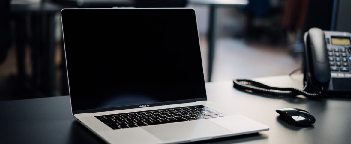 macbook pro on white table